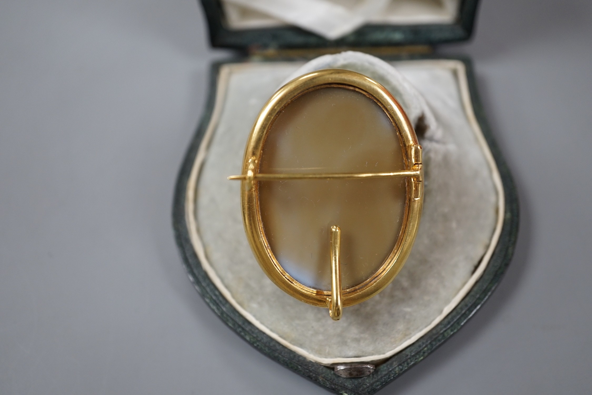 A Victorian yellow metal mounted agate cameo oval brooch, carved with the head of a lady to dexter, 41mm, in fitted initialled leather case.